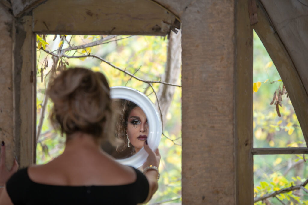 Young woman in a stylish black Halloween costume with spooky makeup