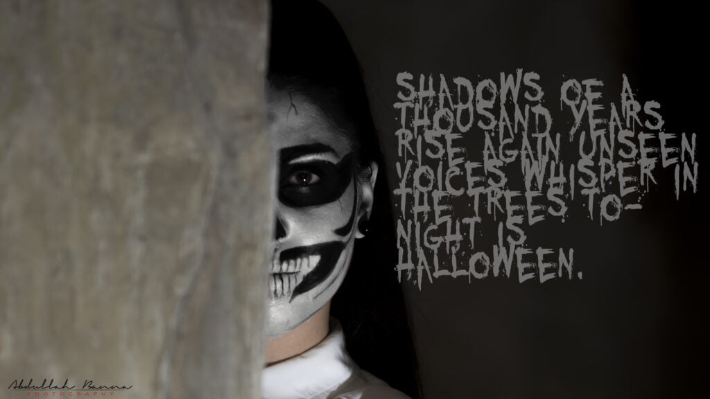 Elegant Halloween attire with a touch of black and spooky makeup, worn by a lady.