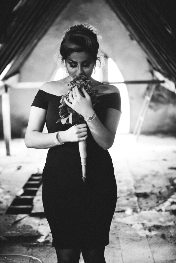 Elegant Halloween attire with a touch of black and spooky makeup, worn by a lady for Halloween