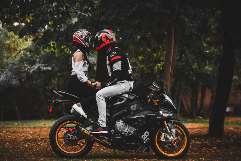 couple riding a motorcycle during a photoshoot
