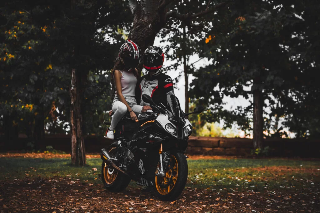 couple riding a motorcycle during a photoshoot