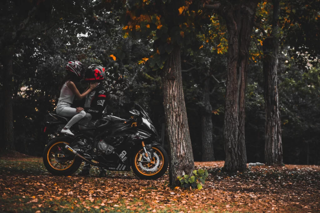 couple riding a motorcycle during a photoshoot