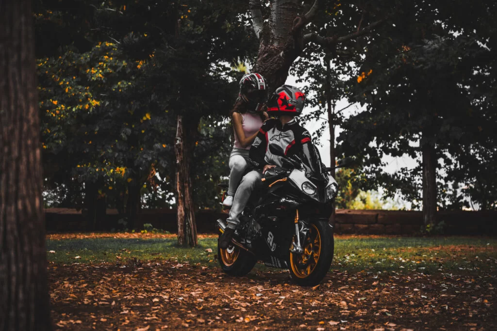 couple riding a motorcycle during a photoshoot