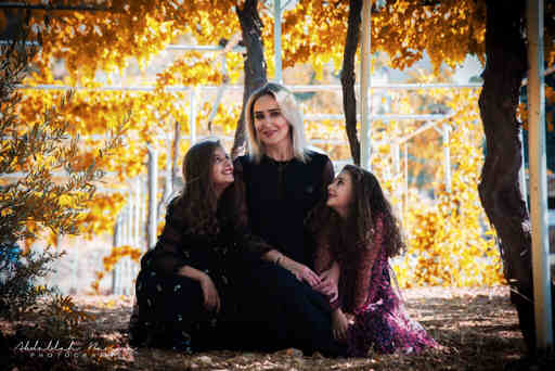 a mother and two daughters posing for a family photoshoot