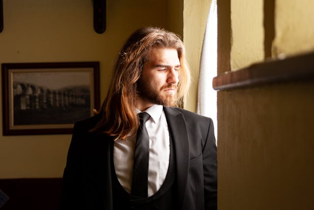 groom looking out a window