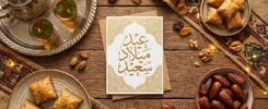 Traditional Arab birthday setting with sweets and a greeting card.
