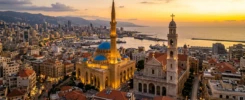 A mosque and a church standing side by side in the Beirut skyline at sunset