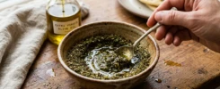 Mixing Za'atar spice blend with olive oil in a small bowl